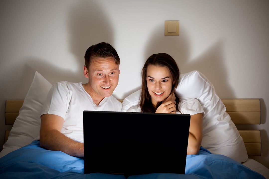 happy couple watching a video